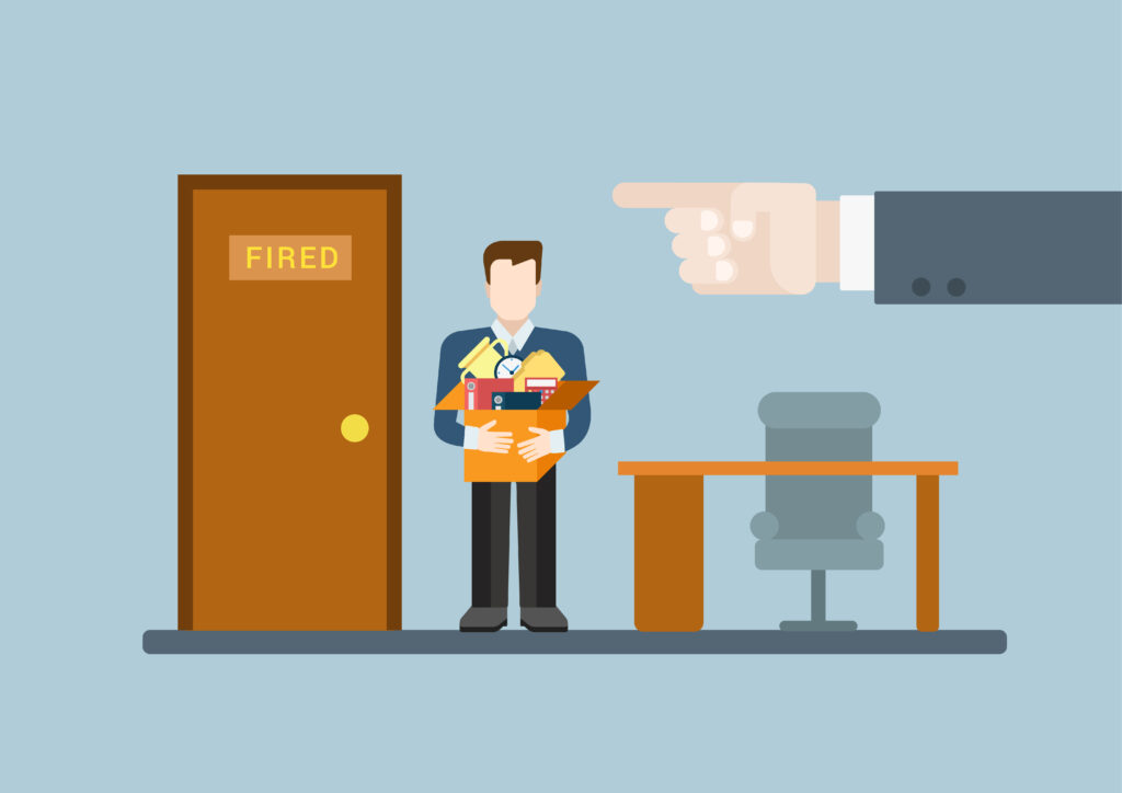 cartoon drawing of an employee being fired, in their office with a desk and chair, holding a cardboard box to their chest full of their personal belongings, with hand and index finger looming over him to his right, pointing to the door indicating he's fired and should leave immediately