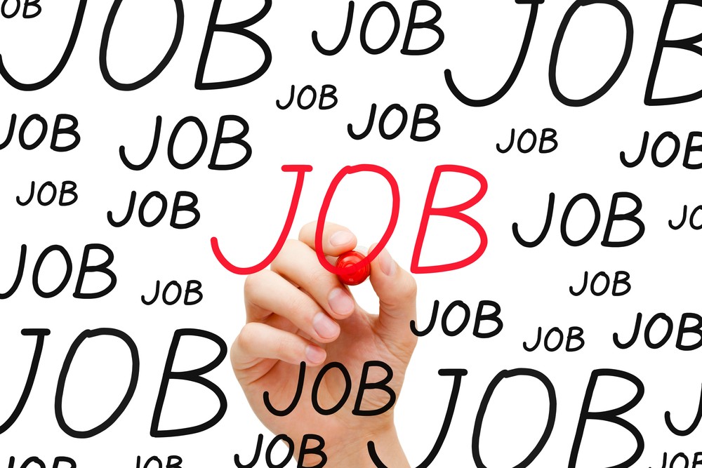 dozens of hand written word "JOB" all in black save for one which has just been written in red so as to stand out, the hand and marker responsible for it putting the finishing touches upon it