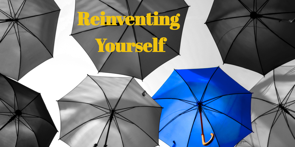 series of grey umbrellas save for one that is blue and stands out from the crowd, in yellow writing the words "Reinventing Yourself" are overlaid against one of the grey umbrellas