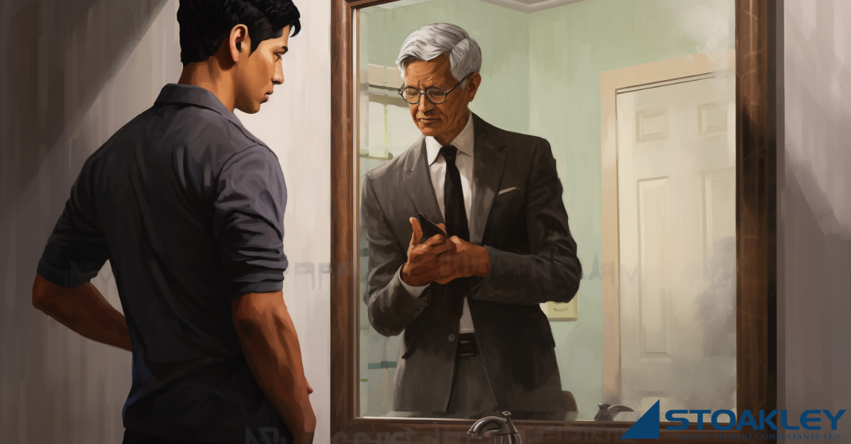 A younger version of an Asian professional stands in front of a mirror reflecting an older version of himself. Both appear deep in thought